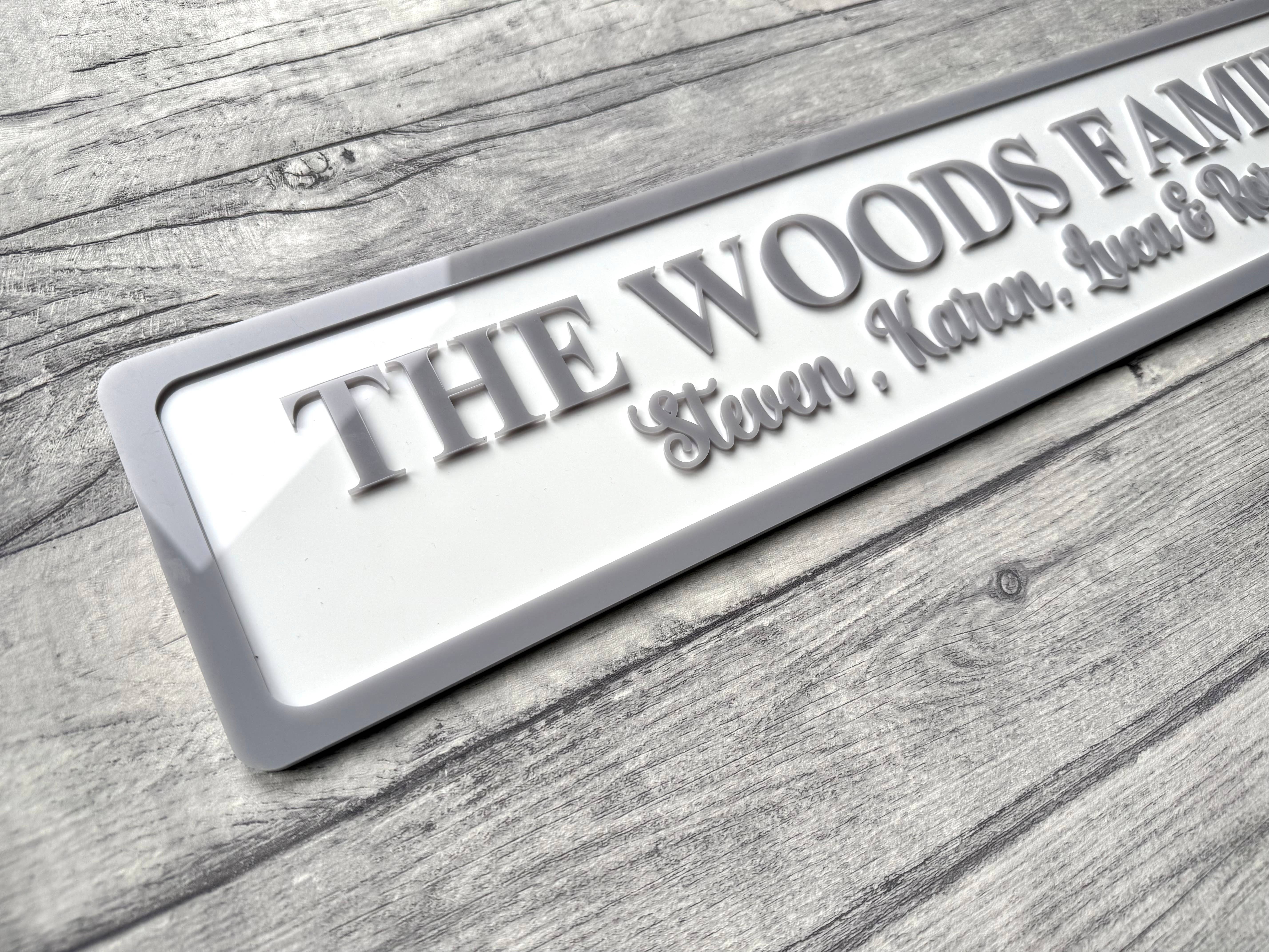 Personalized family nameplate on a wooden surface